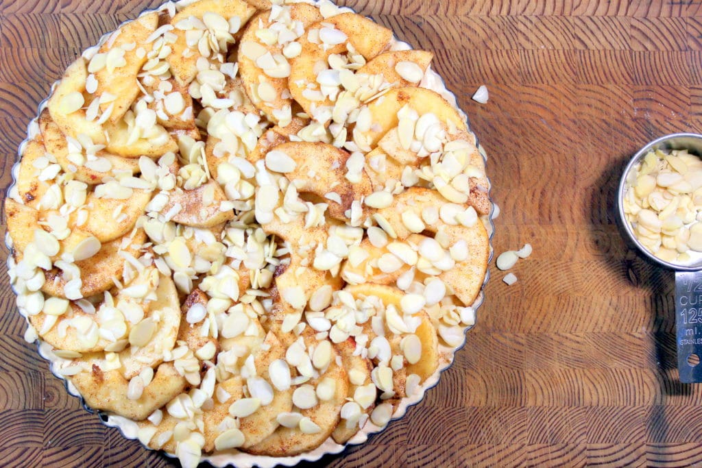 Apple pie topped with slivered almonds.