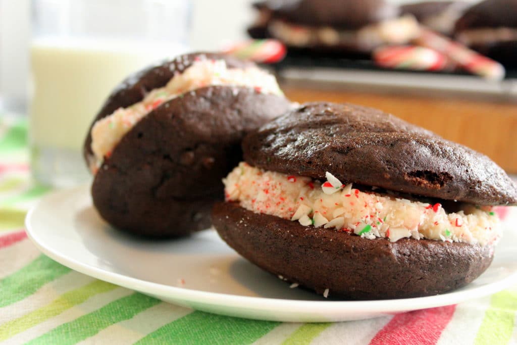 Chocolate Christmas cookies with icing and crushed candy canes in middle.