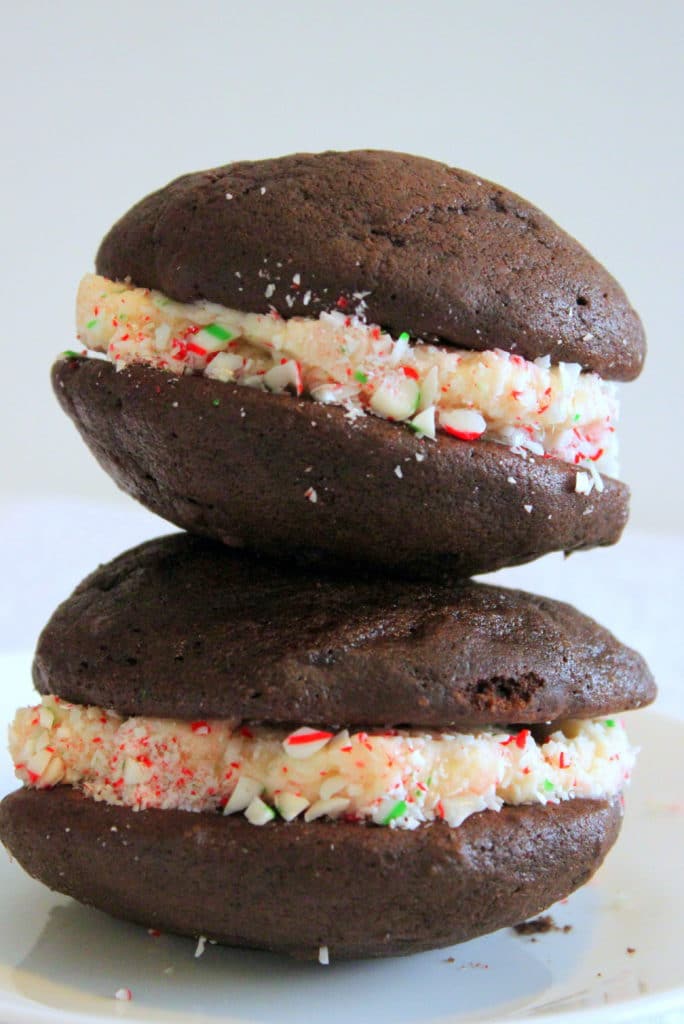 Chocolate Christmas Cookies filled with Candy Cane Icing on White Plate.