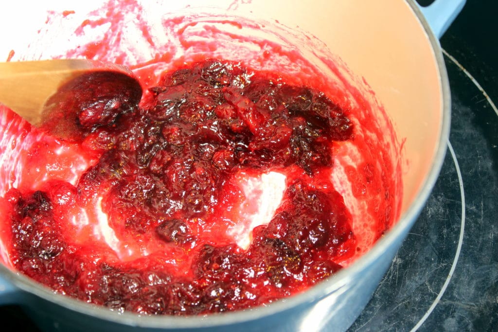 Cooked Cranberries in blue pot.