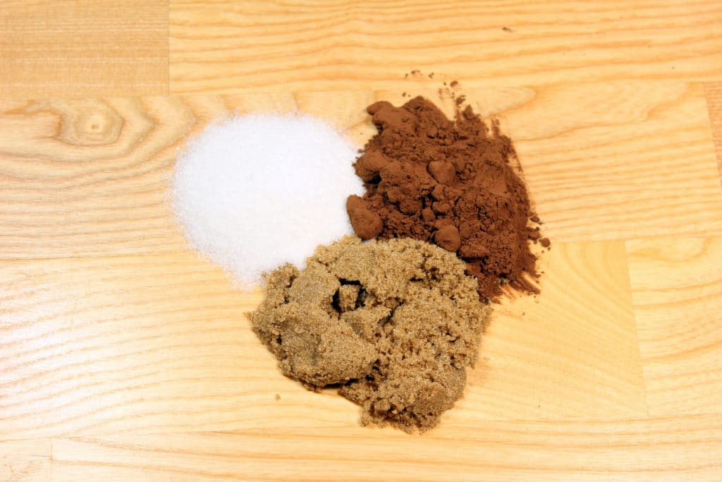 Sugar, Cocoa Powder and Brown Sugar on wood background.