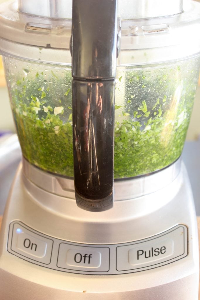 Green Goddess Dip ingredients chopped inside food processor.