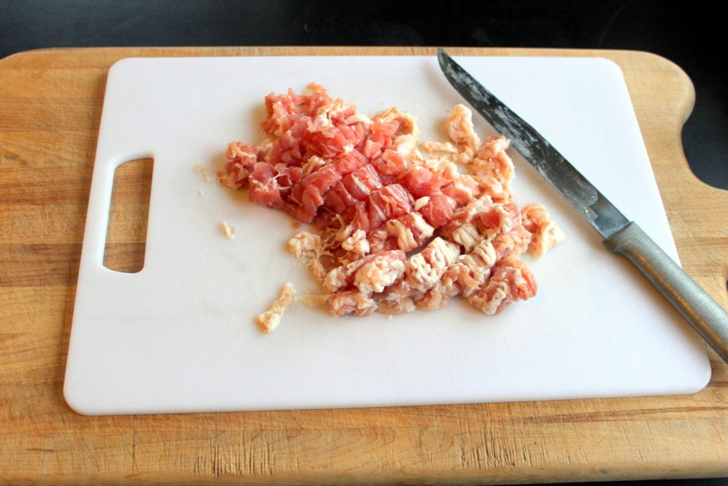 Chopped Raw Bacon on White Cutting Board.