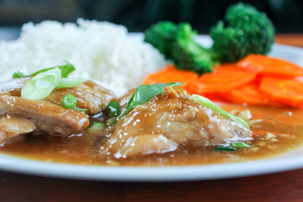 Brown Sugar Garlic Chicken topped with Green Onion, Rice, Broccoli and Carrots in White Plate.