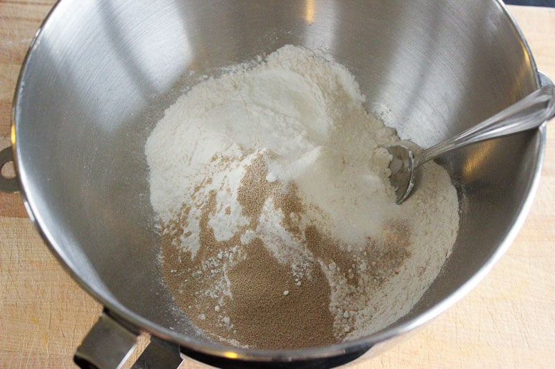 Flour, salt, yeast and sugar in metal mixing bowl.