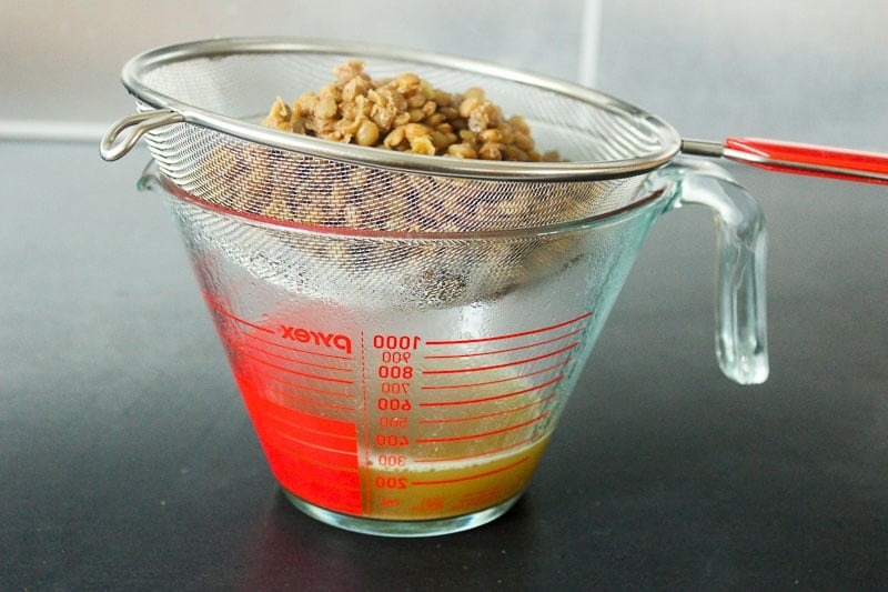Straining Lentils in Glass Measuring Cup.