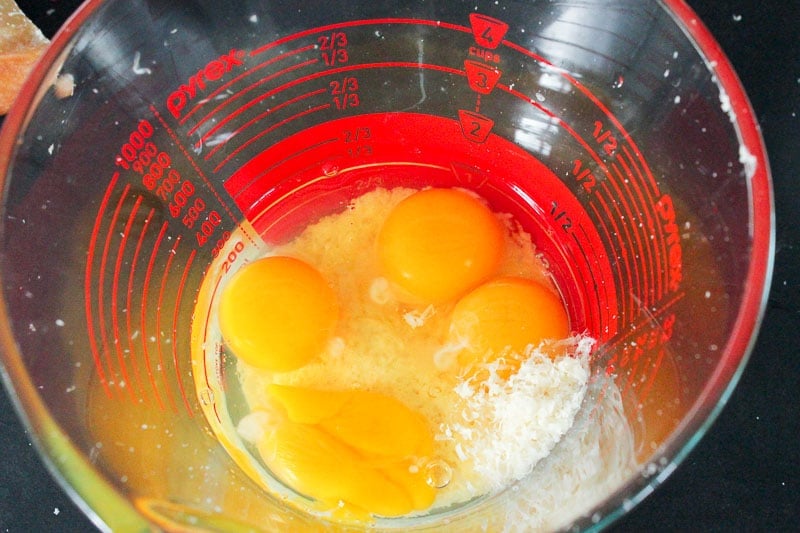 Eggs and Parmesan Cheese in Glass Measuring Cup.