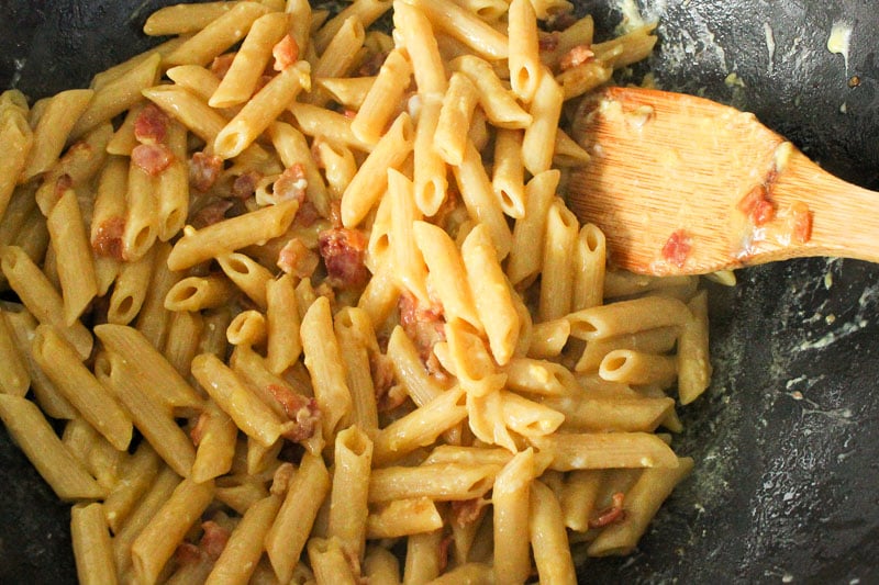 Pasta Carbonara and Bacon mixed in wok.