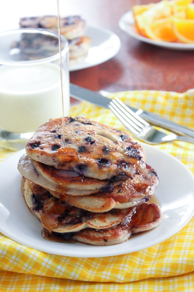 Yogurt Blueberry Pancakes Stacked on White Plate.