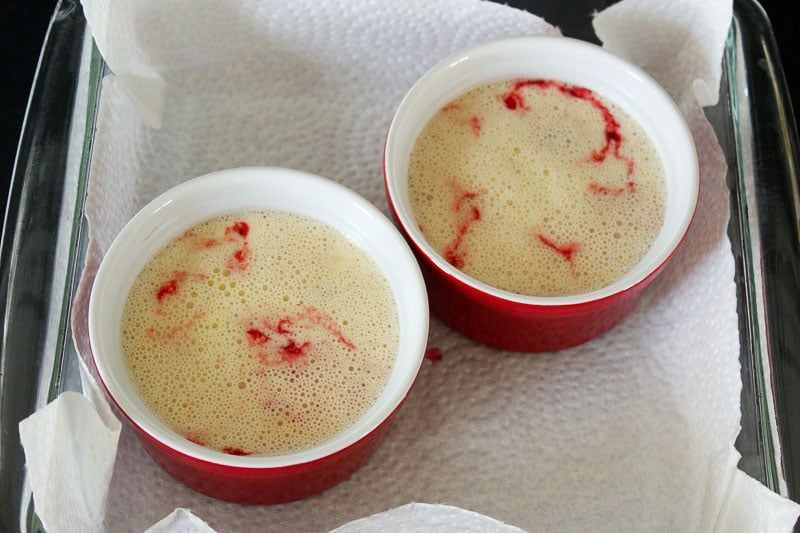 Creamy Raspberry Creme Brûlée Mixture in Red Ramekins. 