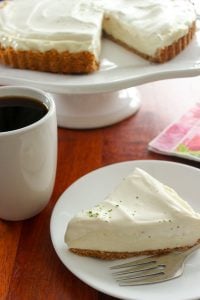 Easy Key Lime Pie on platter, with slice in plate and cup of coffee