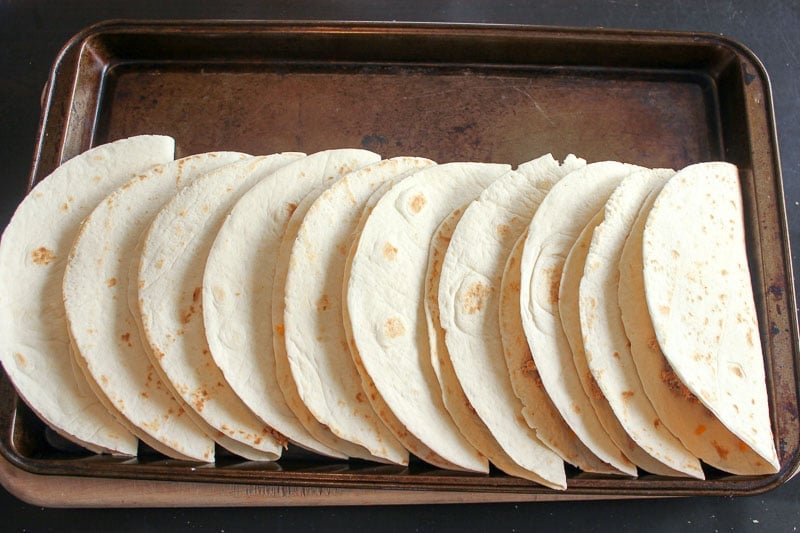 Folded Quesadillas on a sheet pan.