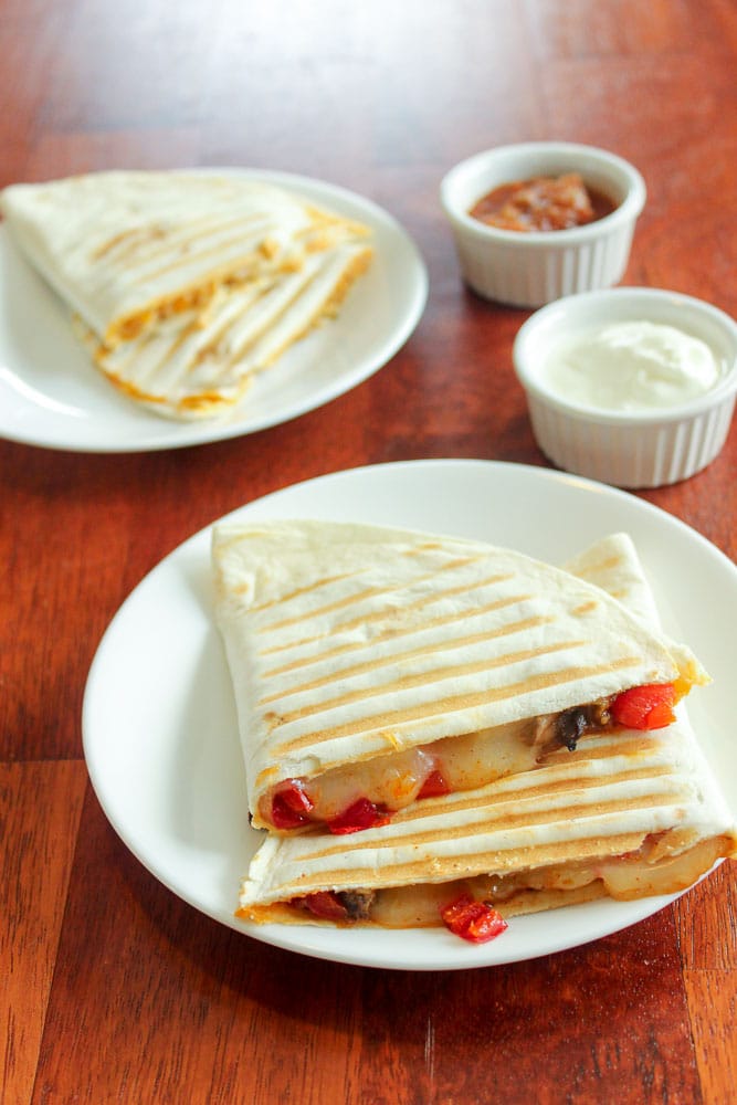 Sliced Quesadillas on small white plates.