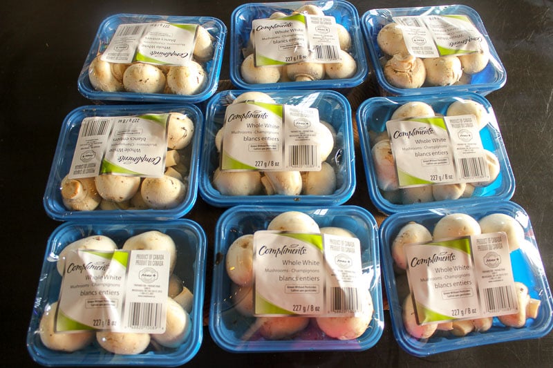 9 containers of plastic wrapped mushrooms
