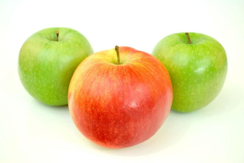 A red apple between 2 green apples.