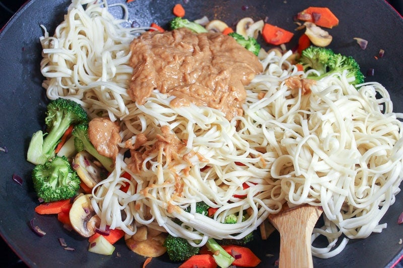 Vegetables, noodles and brown sauce in wok.