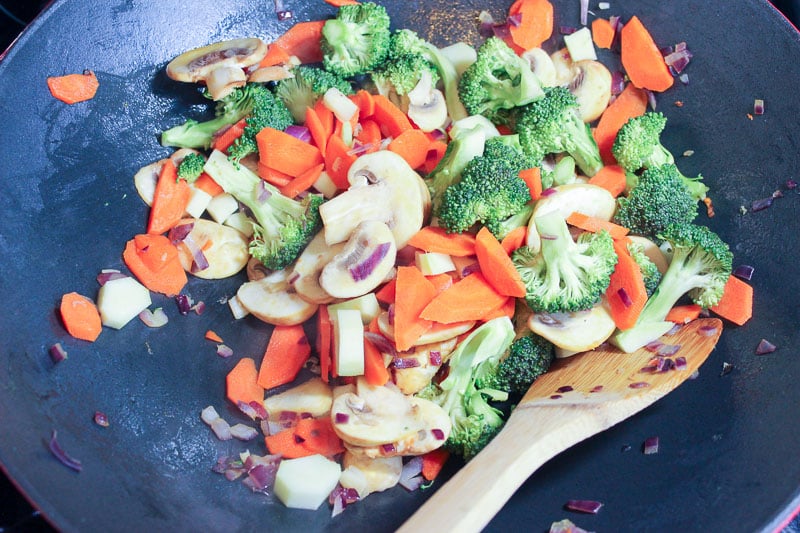 Vegetables frying in wok.