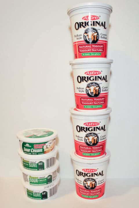 Yogurt and sour cream tubs stacked.