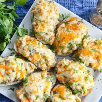 These Easy Loaded Twice Baked Potatoes are easy to make ahead of time and a huge crowd pleaser! Try them out and be the star of your next potluck or family gathering, any time of year!