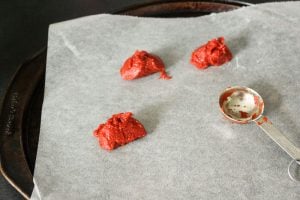 3 Spoonfuls on Tomato Paste on Parchment Paper.