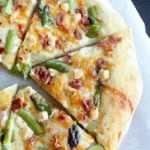 Asparagus Bacon Goat Cheese Pizza - easy to make, and perfect for spring. Fresh asparagus, smoky bacon, salty goat cheese and a garlic sauce make every bite of this pizza fantastic.