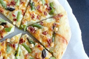 Asparagus Bacon Goat Cheese Pizza - easy to make, and perfect for spring. Fresh asparagus, smoky bacon, salty goat cheese and a garlic sauce make every bite of this pizza fantastic.