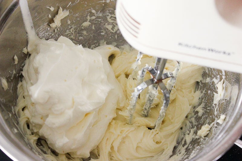 Whipping Cream and Cream Cheese mixed in Metal Mixing Bowl.