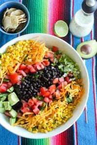 Mexican Salad in White Bowl on Colourful Cloth Background.