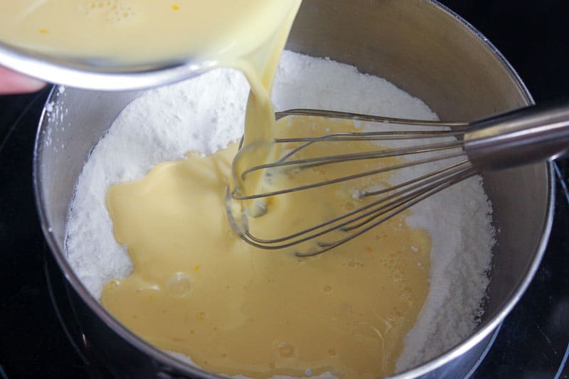 Adding Egg and Milk Mixture to Sugar, Cornstarch and Salt Mixture.