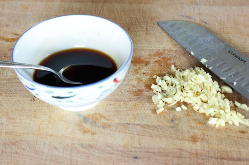 Minced Garlic on Wooden Board.