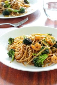 Cajun Pasta Topped with Shrimp and Broccoli on White Plate.