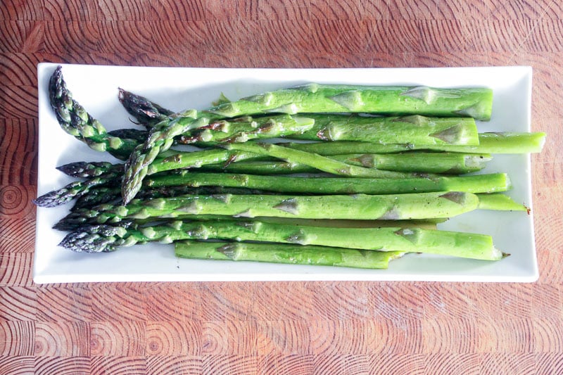 Roasted Asparagus on White Plate.