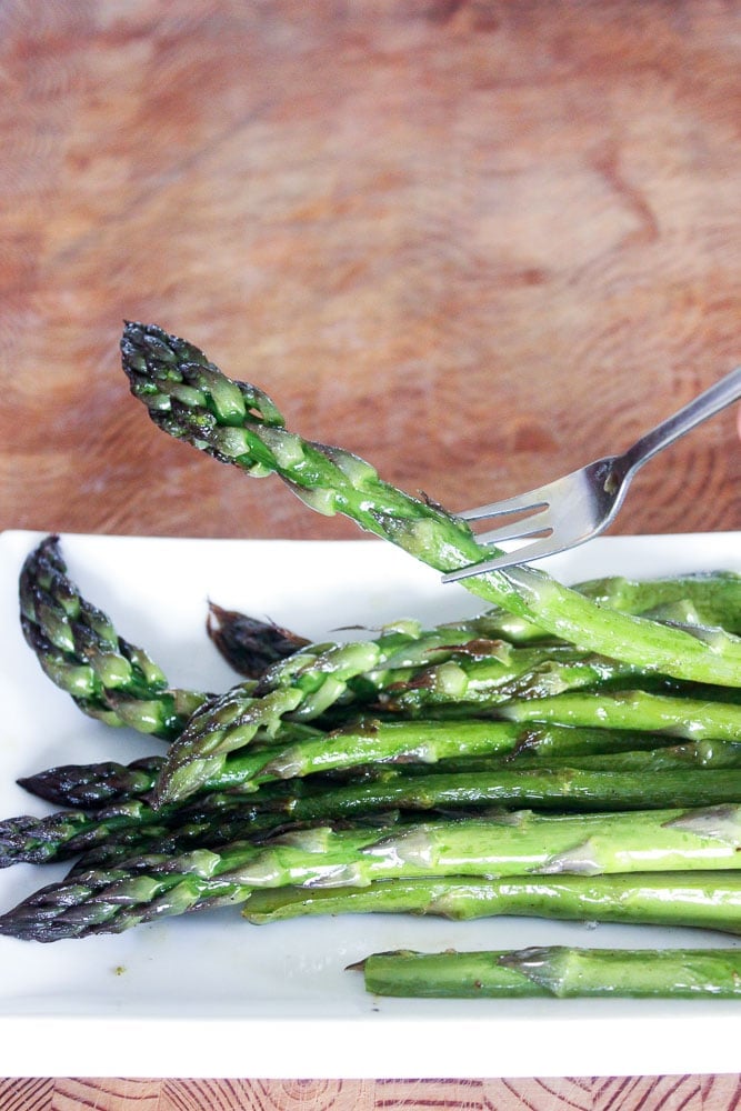 Roasted Asparagus Spears on White Plate.