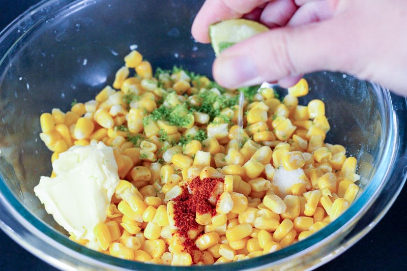 Kernel Corn, Spices and Lime Zest in Glass Mixing Bowl.