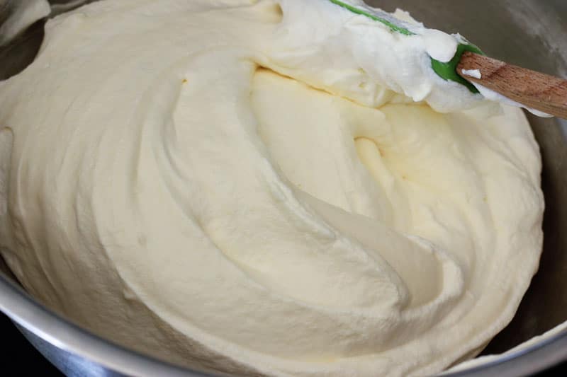 Folding Whipping Cream into Batter in Metal Mixing Bowl.