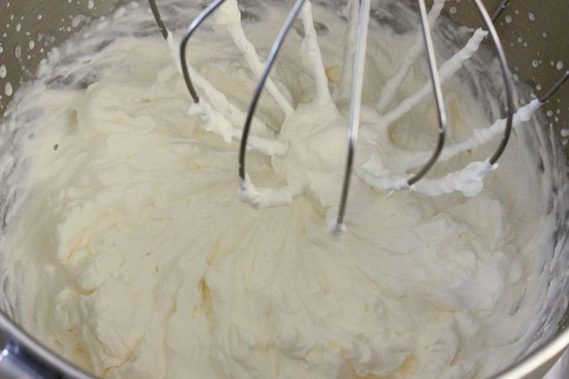 Whipping Cream in Metal Mixing Bowl.