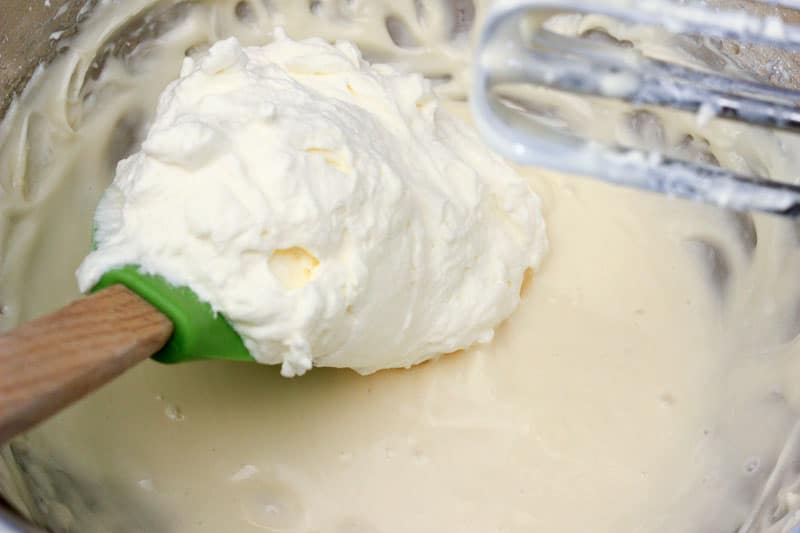 Whipping Cream Added to Metal Mixing Bowl.