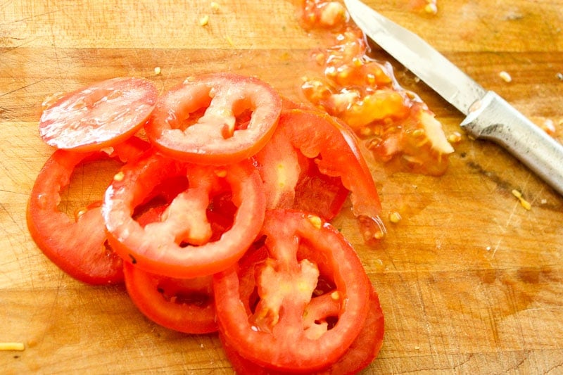 Sliced Tomatoes on Wooden Board.