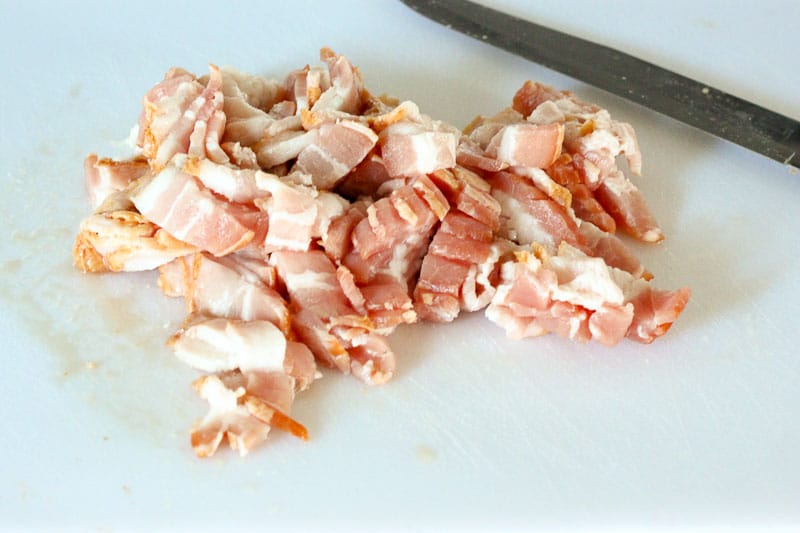 Chopped Raw Bacon on White Board.