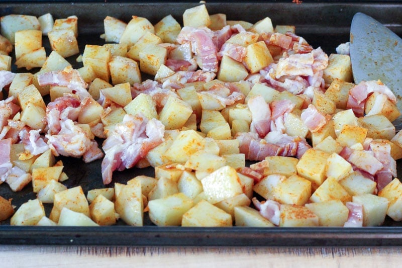 Cubed Potatoes and Chopped Bacon on Sheet Pan.