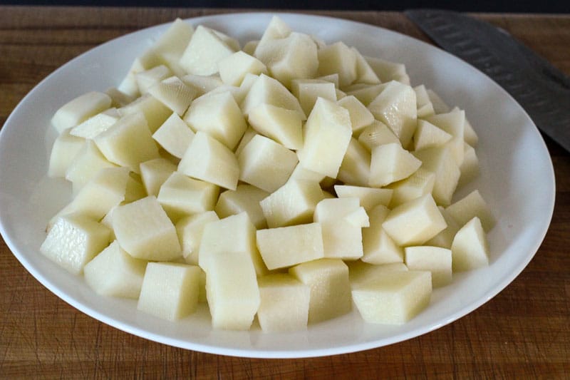 Cubed Potatoes on White Plate.