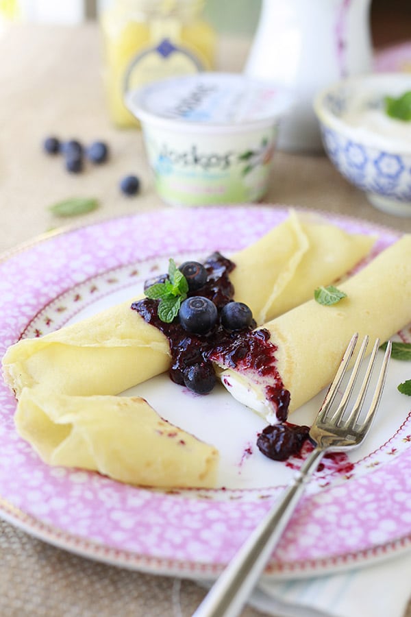 Crepe topped with Blueberries in Pink and White Plate.
