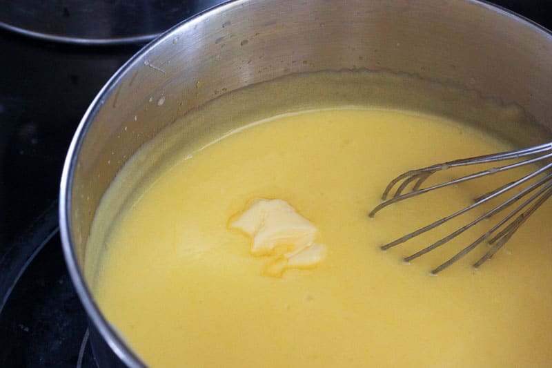 Adding Butter to Lemon Mixture in Metal Pot.