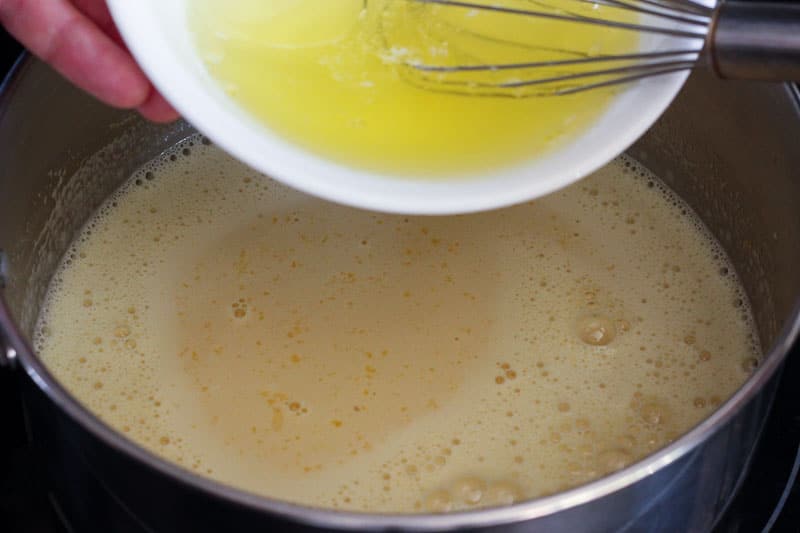 Adding Egg Whites to Lemon Mixture in Metal Pot.