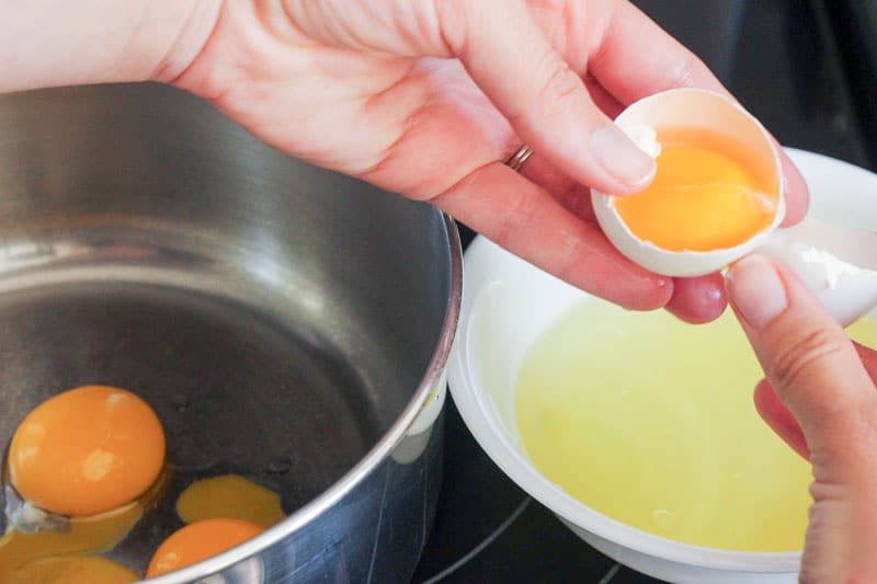 Separating Egg Yolks into Metal Mixing Bowl.