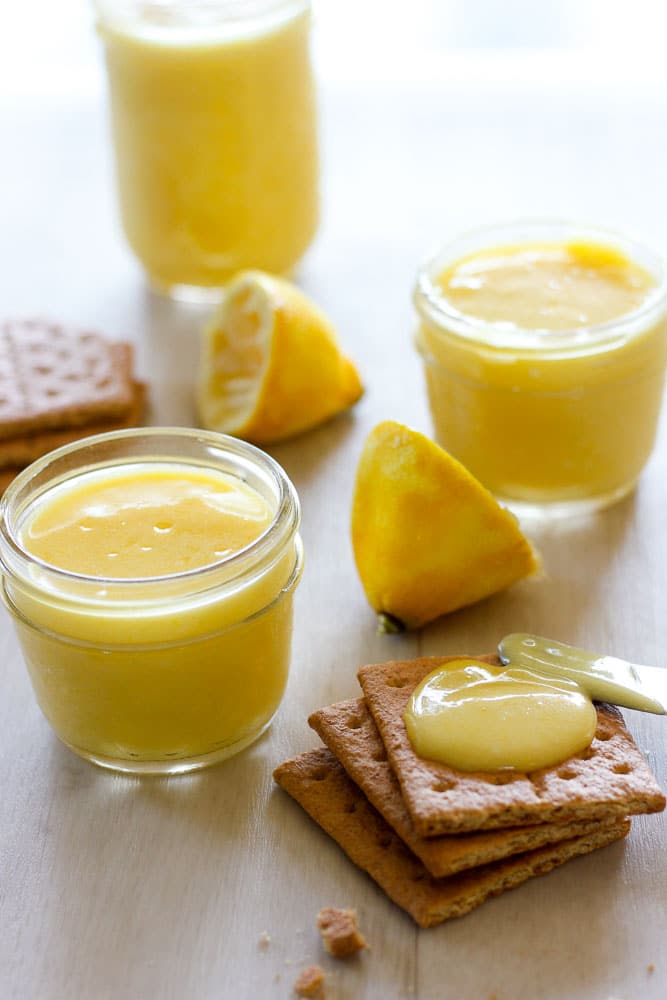 Lemon Curd in Glass Jars and Graham Crackers topped with Lemon Curd.