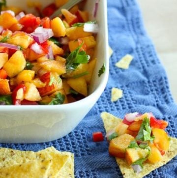 Peach and vegetable salsa in white bowl.