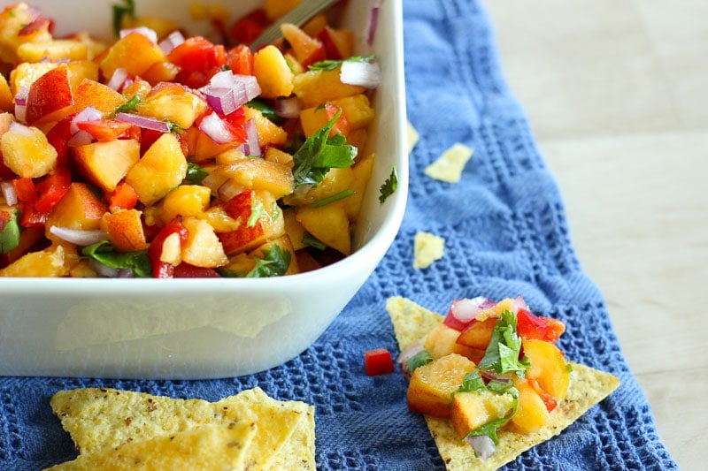 Peach Salsa in White Dish on Blue Cloth.