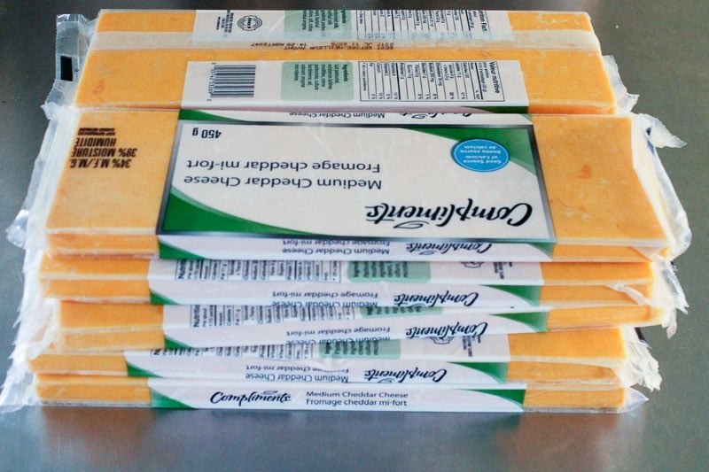 Stack of Cheddar Cheese in Packages.