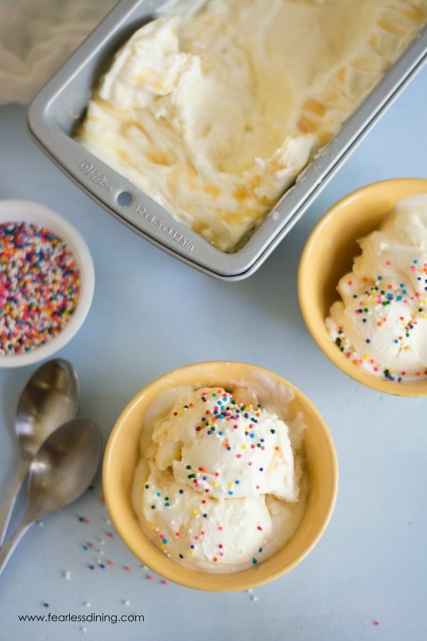 Lemon Curd Ice Cream topped with rainbow sprinkles.